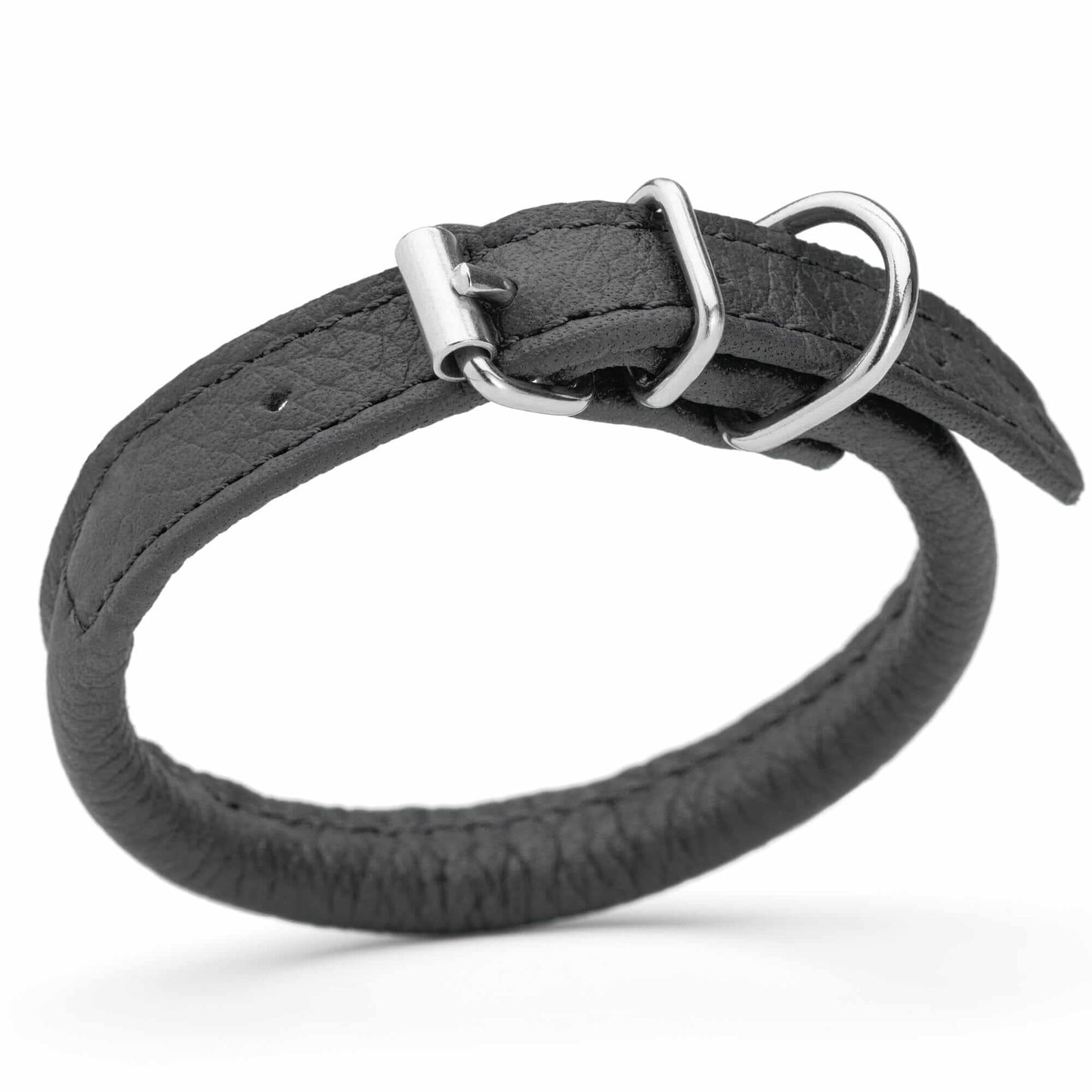Dog wearing a white soft leather round collar sitting in the park with owner