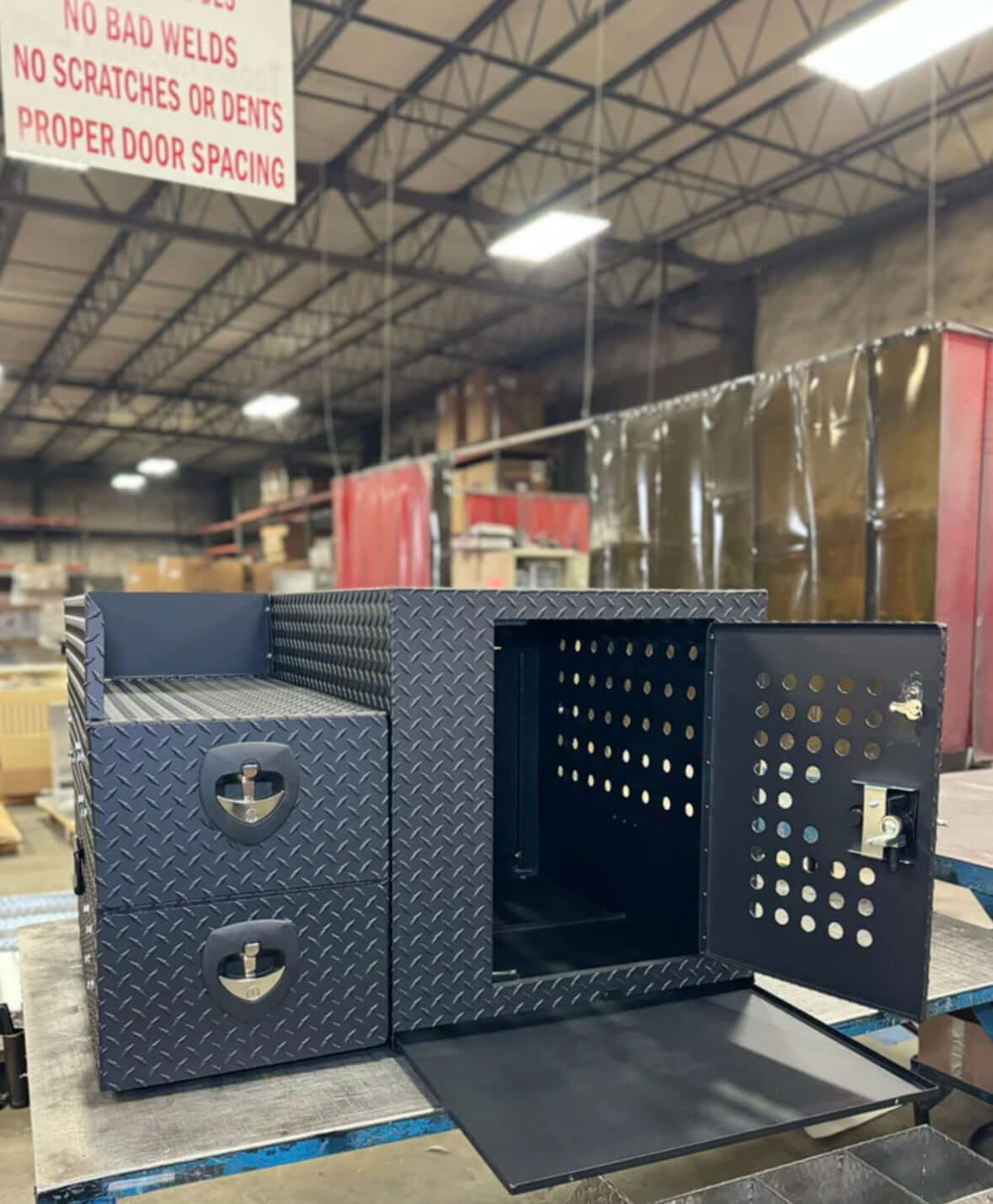 Owen's Professional K9 Deployment Unit displayed inside a warehouse, showing secure compartments for working dogs and tactical gear