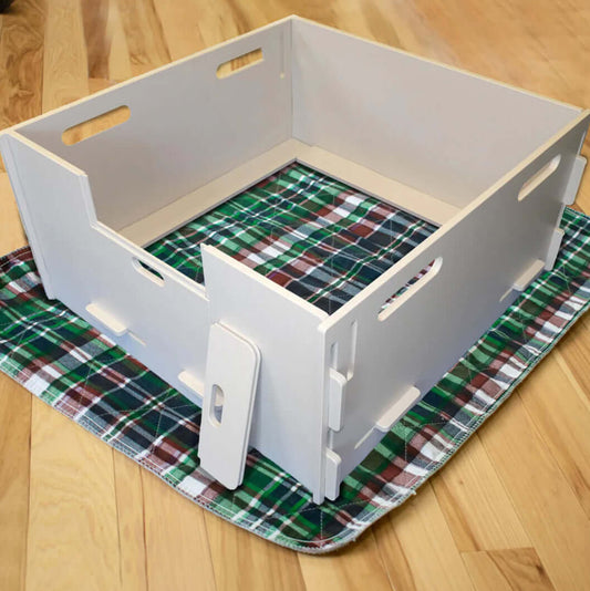 A whelping box for dogs, designed with soft bedding and high sides to provide a safe and comfortable space for a mother dog to give birth and care for her puppies.