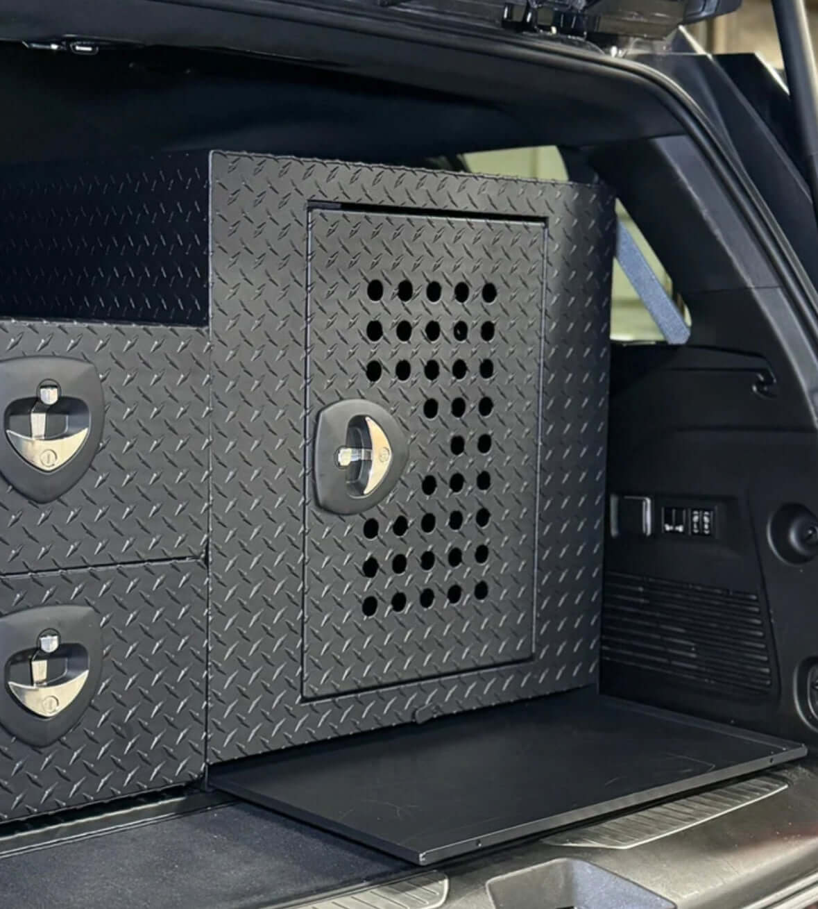 Owen's Professional K9 Deployment Unit installed in an SUV, featuring secure compartments for working dogs and tactical equipment