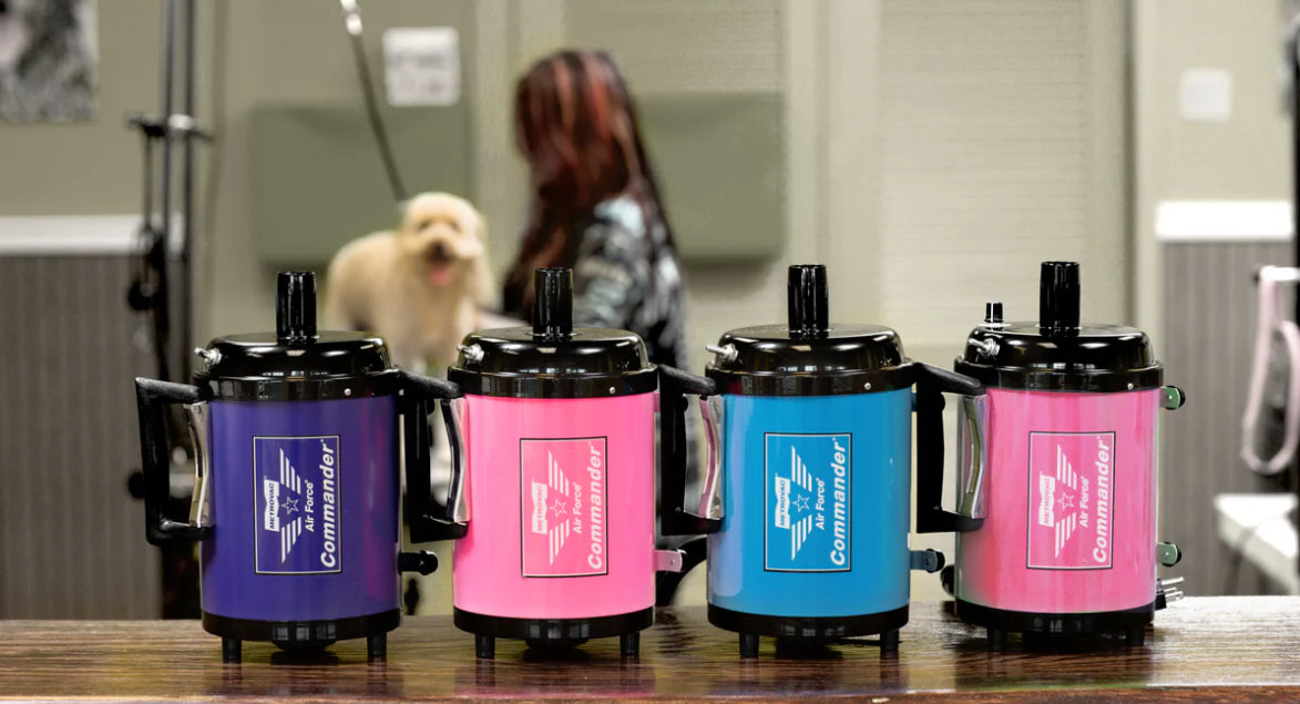 Four Metrovac Air Force Commander 2-speed pet dryer with 1.17 HP motor, 86 CFM airflow, and all-steel construction for efficient grooming in blue pink orange purple