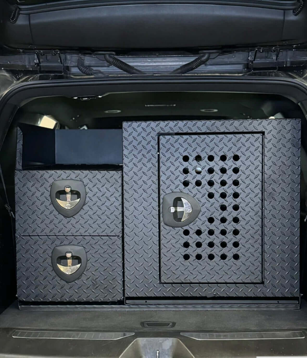 Owen's Professional K9 Deployment Unit installed in an SUV, featuring secure compartments for working dogs and tactical equipment