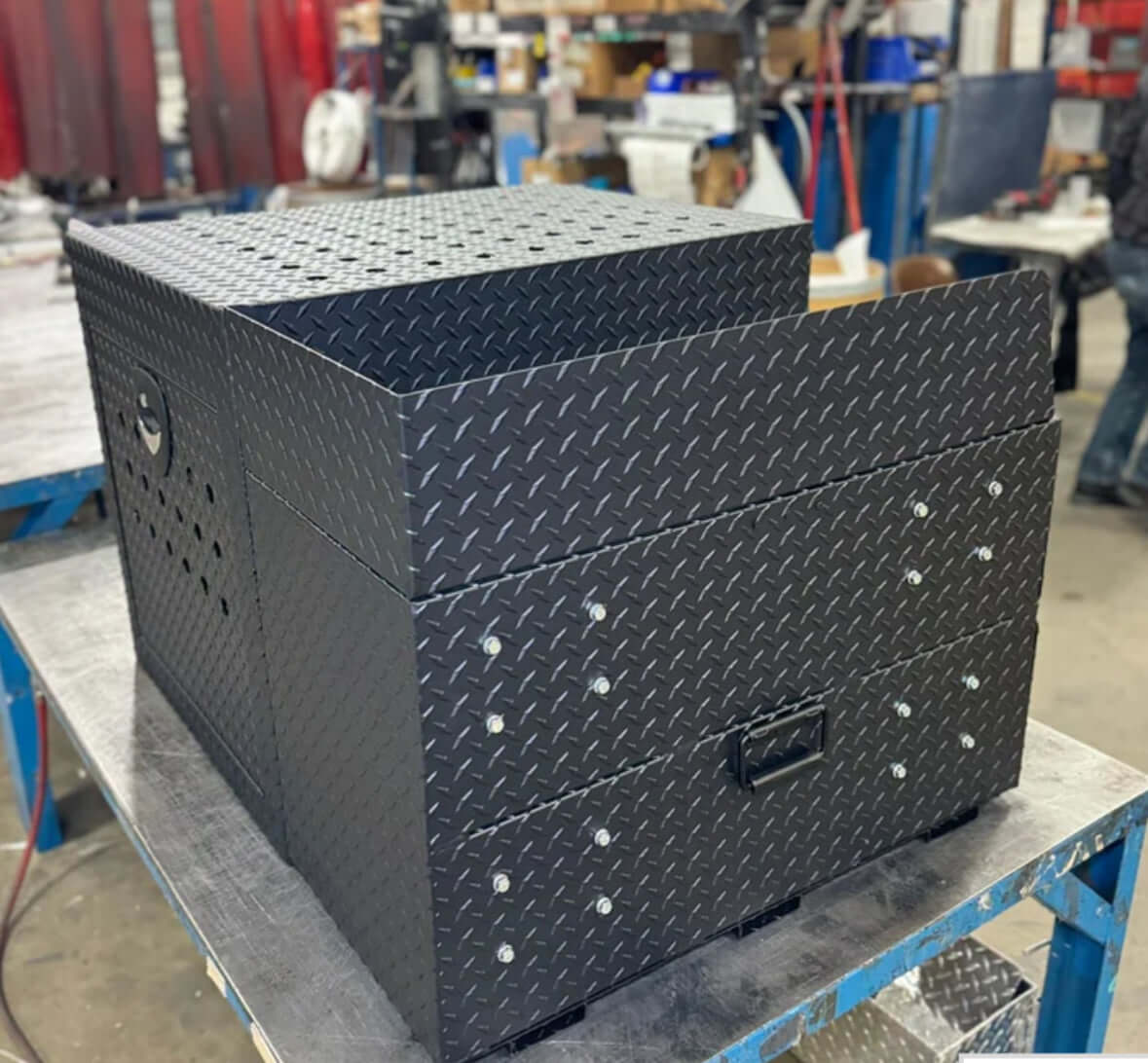 Owen's Professional K9 Deployment Unit displayed inside a warehouse, showing secure compartments for working dogs and tactical gear