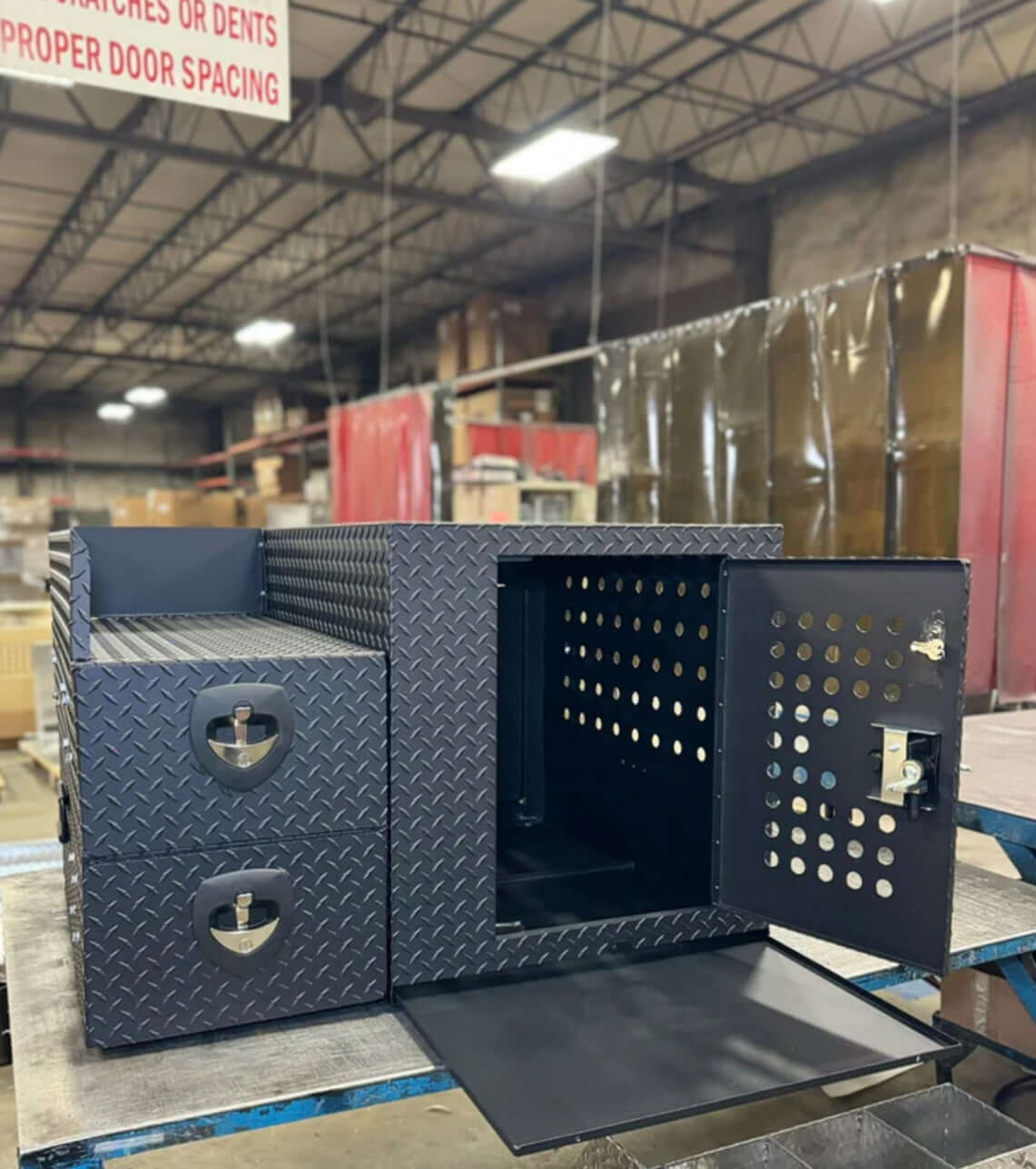 Owen's Professional K9 Deployment Unit displayed inside a warehouse, showing secure compartments for working dogs and tactical gear