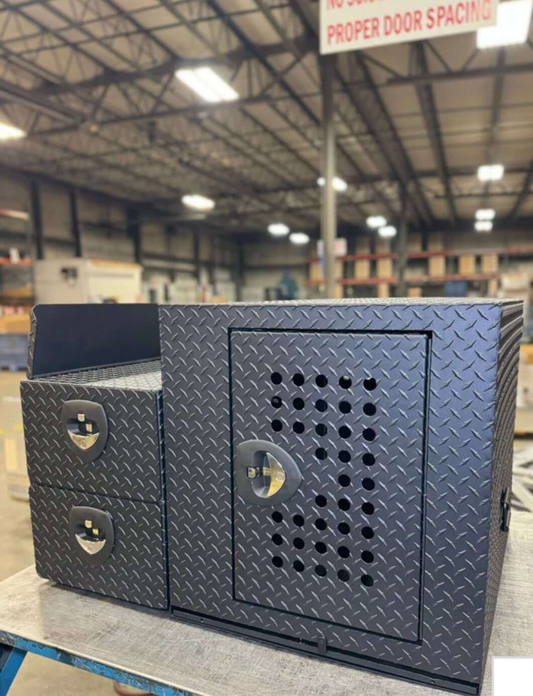 Owen's Professional K9 Deployment Unit displayed inside a warehouse, showing secure compartments for working dogs and tactical gear