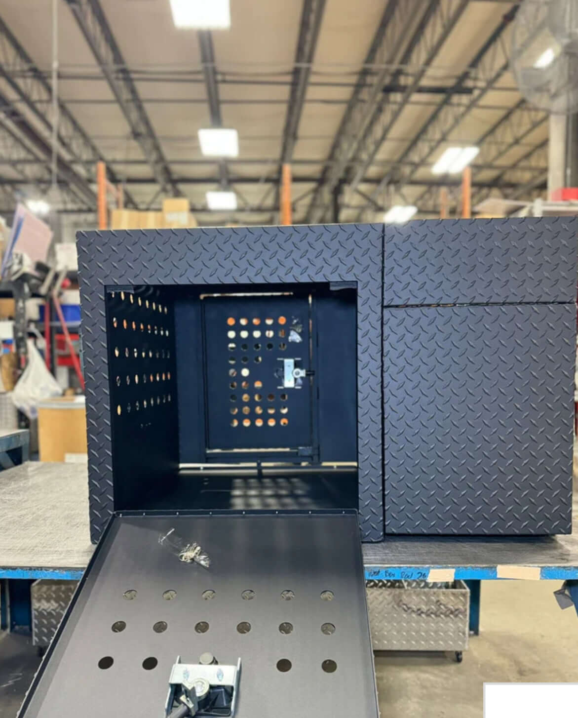 Owen's Professional K9 Deployment Unit displayed inside a warehouse, showing secure compartments for working dogs and tactical gear