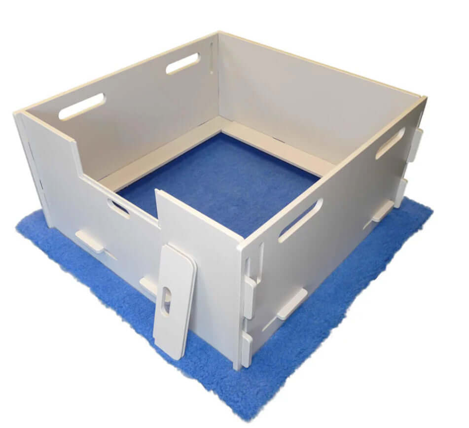 A whelping box for dogs, designed with soft bedding and high sides to provide a safe and comfortable space for a mother dog to give birth and care for her puppies.