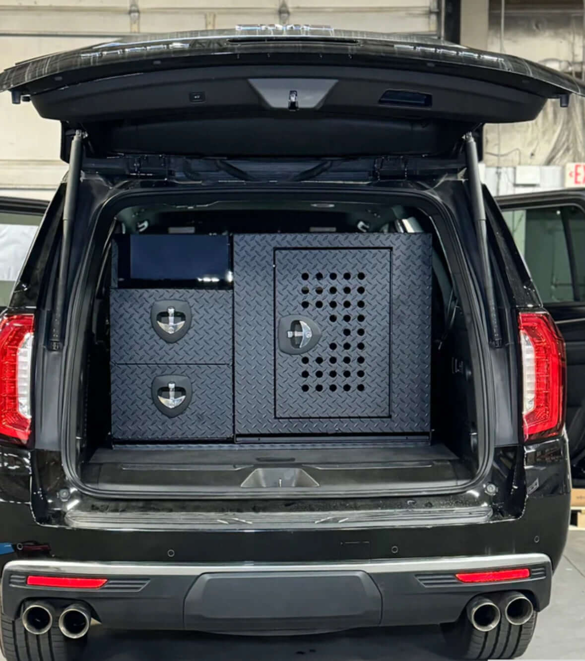 Owen's Professional K9 Deployment Unit installed in an SUV, featuring secure compartments for working dogs and tactical equipment