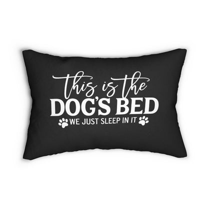 Black pillow with white text 'This is the dog's bed, we just sleep in it' on a white background