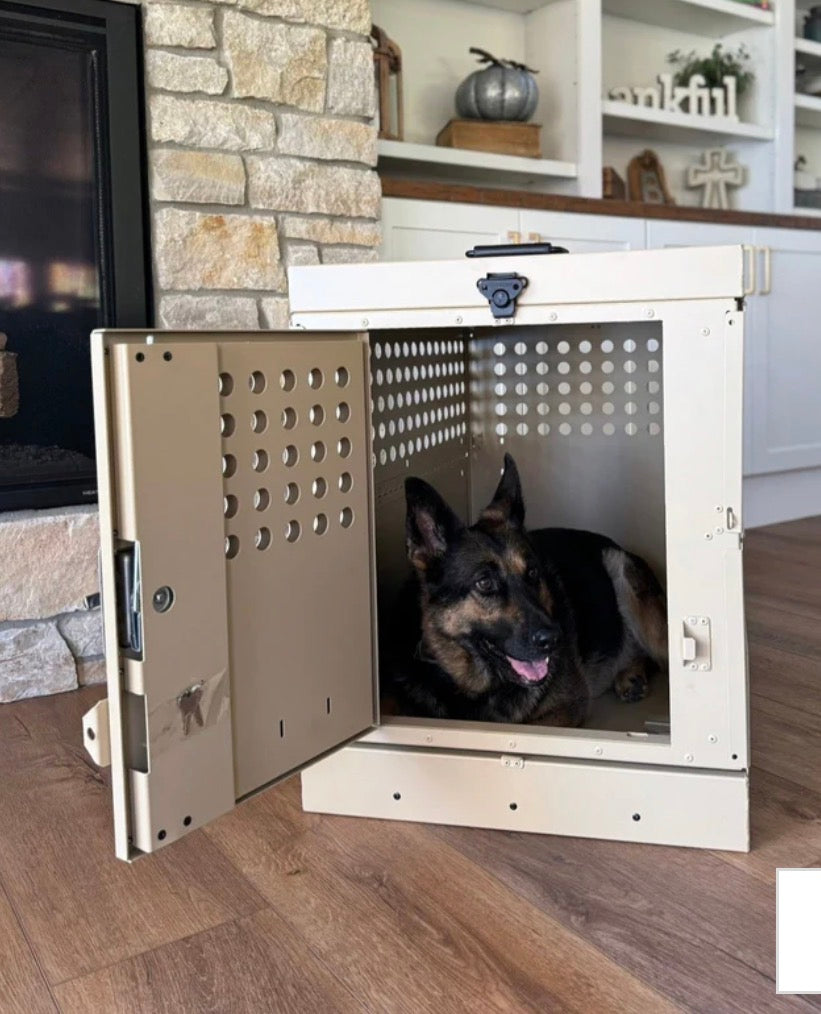 German Shepherd resting inside open door K9 aluminum dog crate inside home