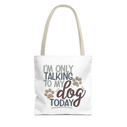 Tote bag with 'I'm only talking to my dog today' text and paw prints on a white background
