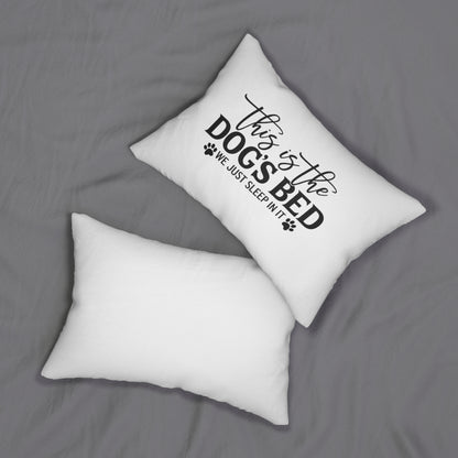 Two white pillows on a gray surface with one pillow featuring black text saying this is the dogs bed we just sleep in it 