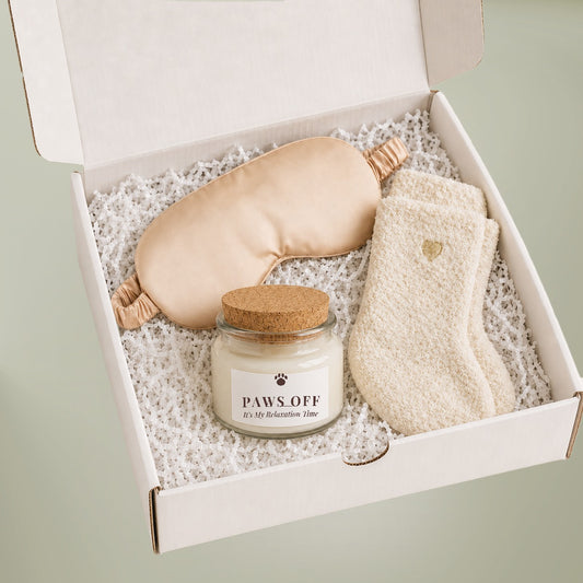 Dog Mom Relaxation Gift Set gift box with Paws Off labeled soy candle, champagne satin sleep mask and ivory cozy socks